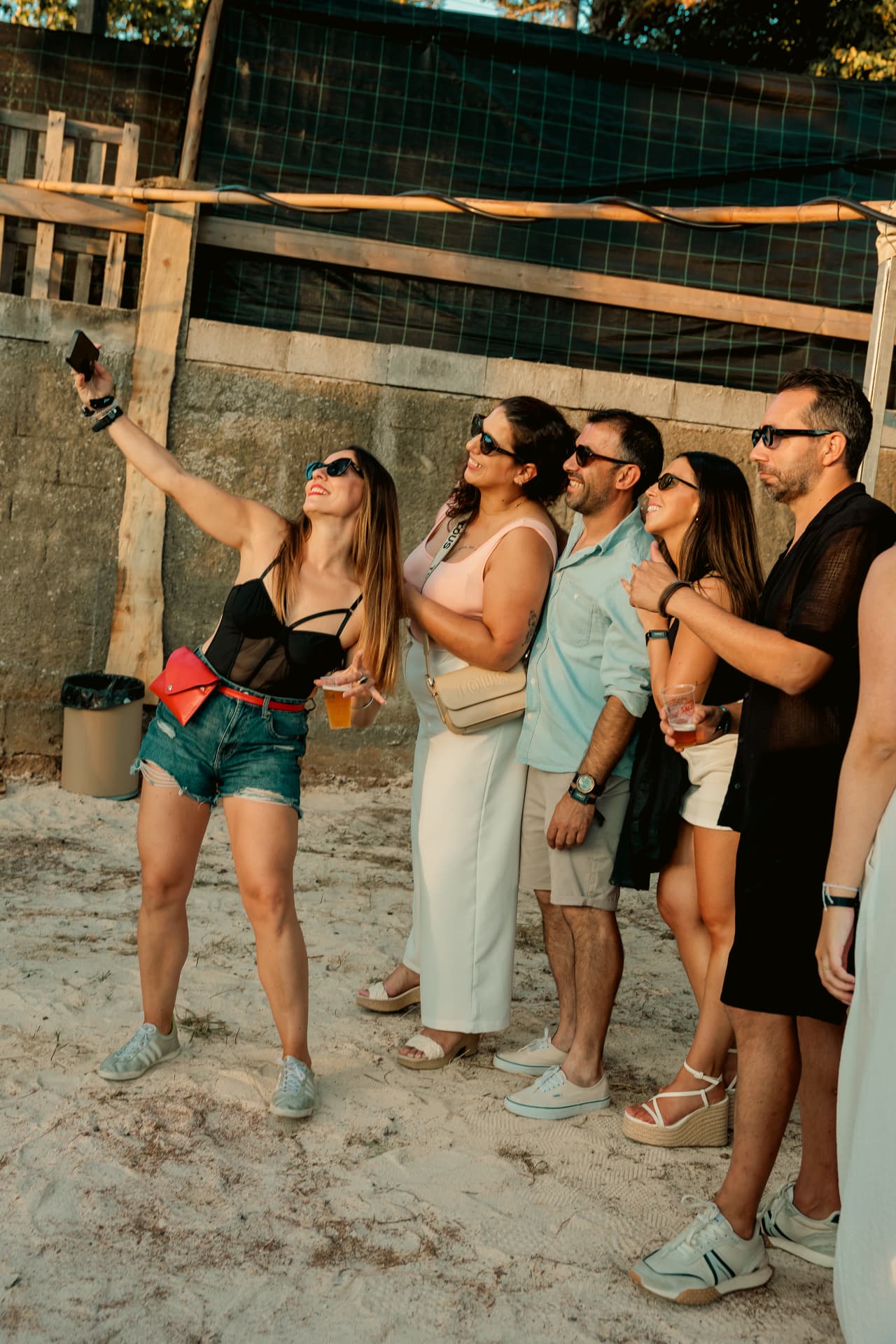 Friends taking a selfie on the sand