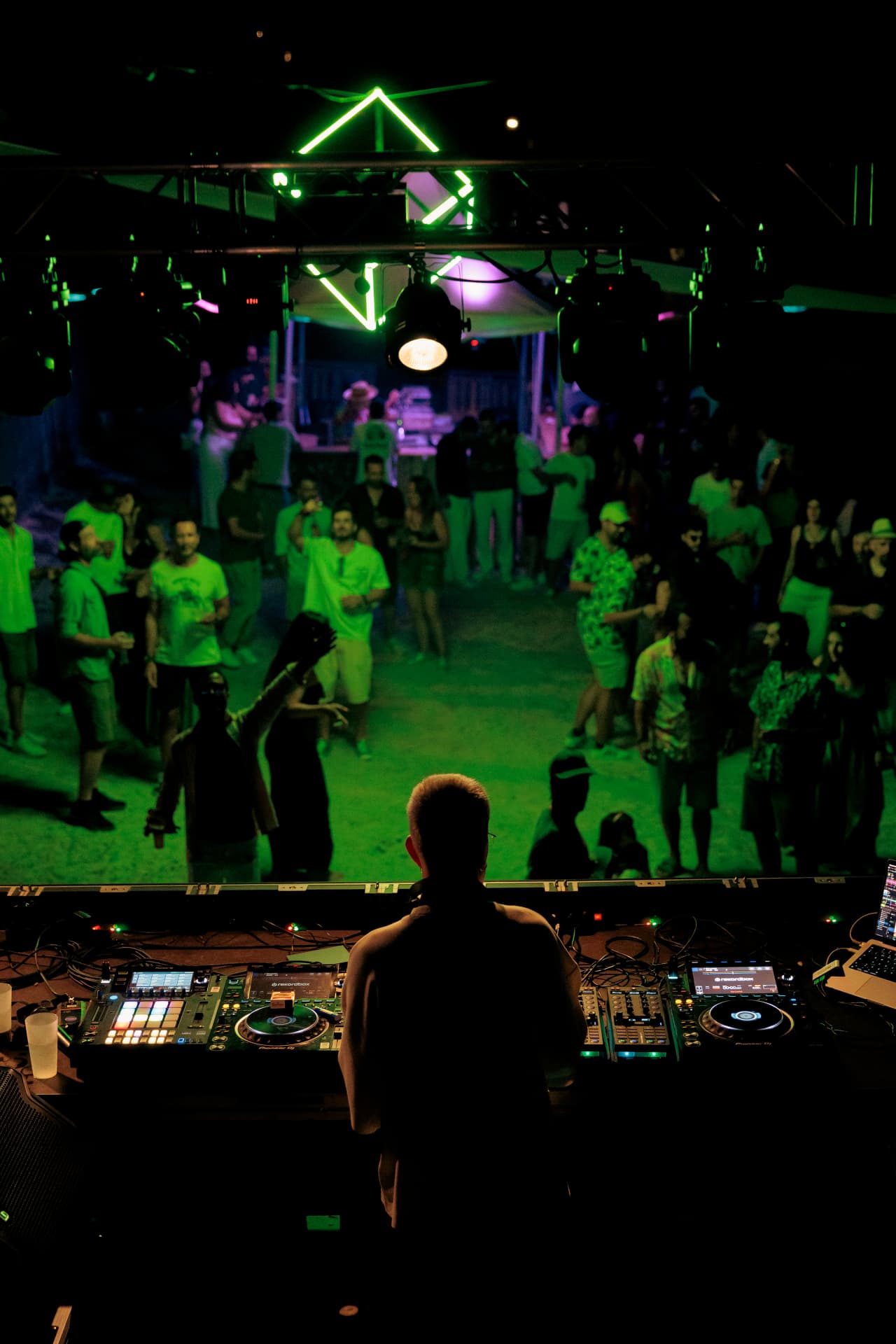 The booth over a crowd bathed in green