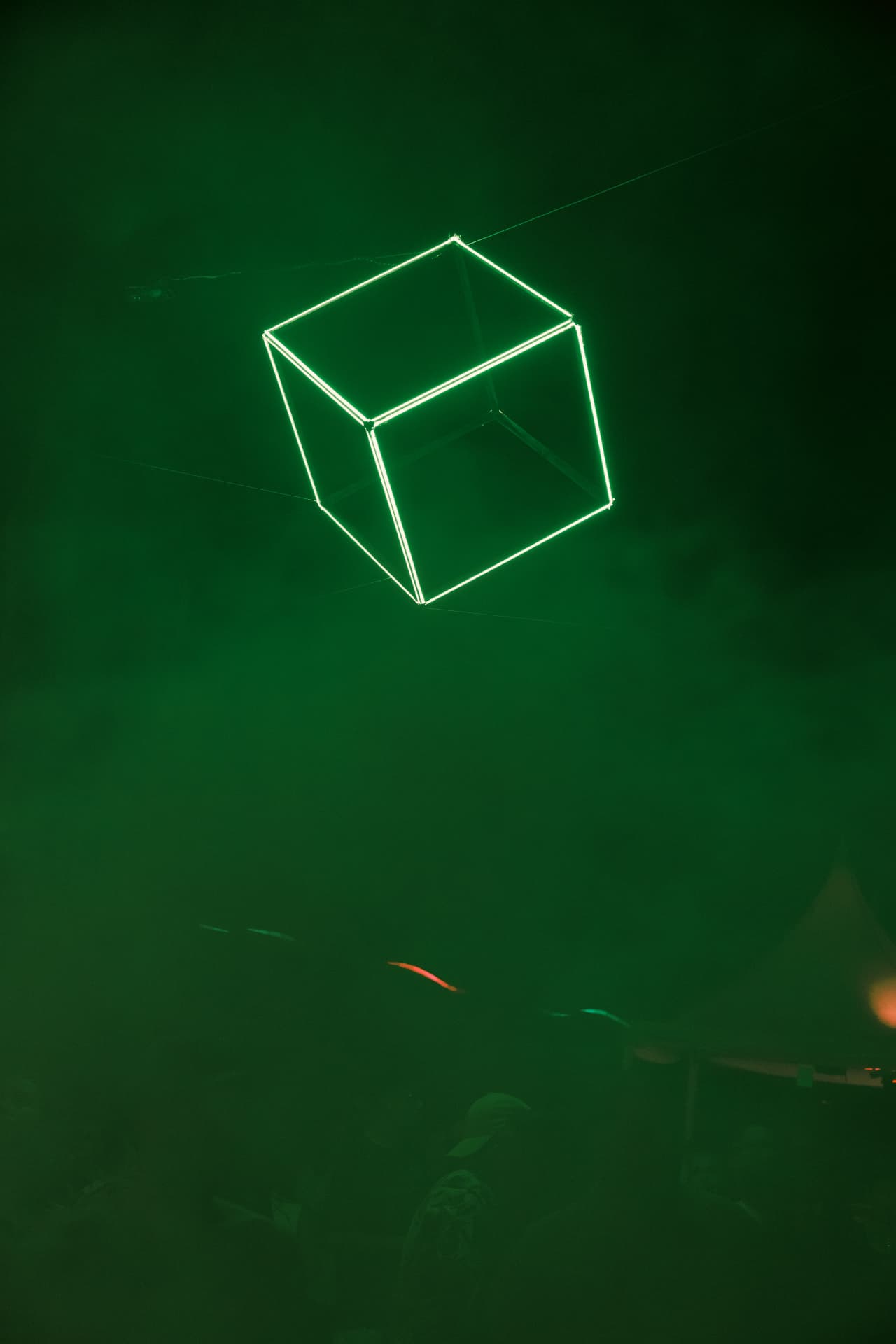 The green wireframe cube in the haze