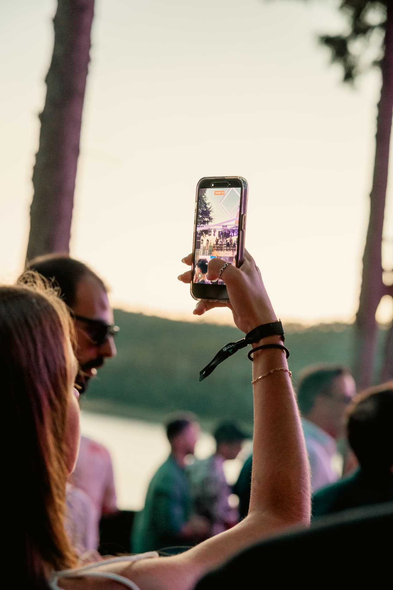 Guest filming the stage against the sunset