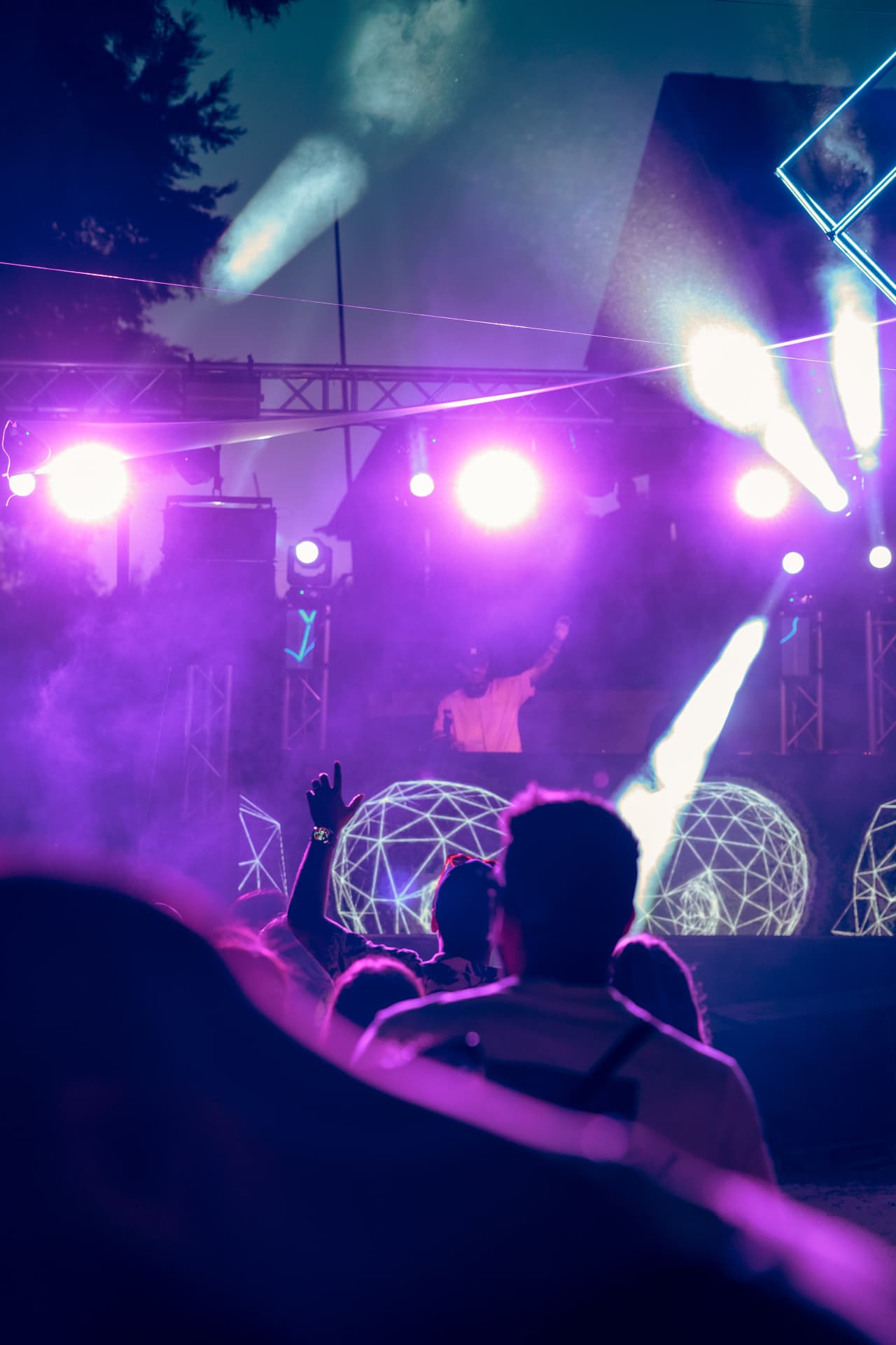 Purple spotlights over the crowd at night
